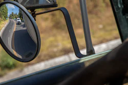 Trucks loaded with avocados reflected in a rear view mirror on the way to Uruapan, Mexico, Jan. 26, 2023.