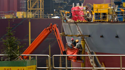 Workers construct the hull of a vessel at the STX shipbuilding plant on Changxing Island, on the outskirt of Dalian, in northeast China's Liaoning province, Sept. 15, 2011.