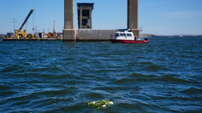 A wreath laid by family members of the victims who died during the collapse of the Francis Scott Key Bridge in Baltimore float in the Chesapeake Bay, March 25, 2025.