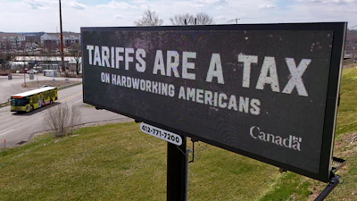 A digital bill board flashes a tariffs message in Kennedy Township, Pa., March 25, 2025.