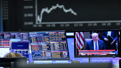 A television monitor showing U.S. President Donald Trump in front of a display board with the Dax curve, Frankfurt, Germany, April 3, 2025.