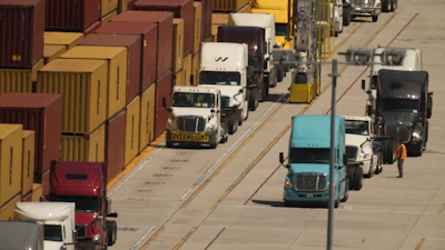 Truck wait to load shipping containers at the Port of Los Angeles, April 9, 2025.