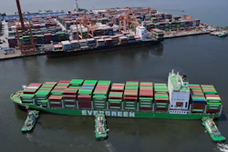 Tugboats assist a container ship at the Manila International Container Terminal, the Philippines, April 8, 2025.