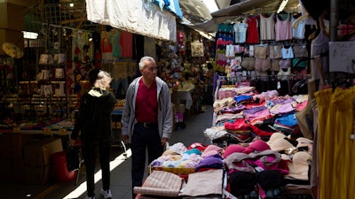 Shoppers move through a market in the Chinatown neighborhood of Los Angeles, April 21, 2025.