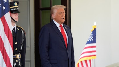 President Donald Trump waits to greet El Salvador's President Nayib Bukele at the White House, Monday, April 14, 2025, in Washington.