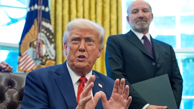 President Donald Trump in the Oval Office with Commerce Secretary Howard Lutnick, April 17, 2025.
