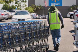 Empty shopping carts are collected from the parking lot at Walmart store in Burbank, Calif., on Thursday, April 10, 2025.