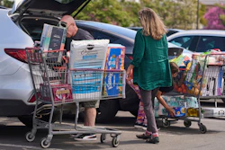 People pack items into their vehicles at Costco store in Burbank, Calif., April 10, 2025.