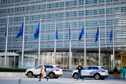 Police cars stand outside EU headquarters in Brussels, Sept. 30, 2022.