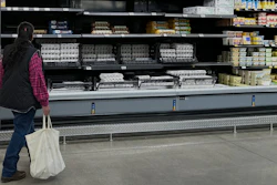 A shopper passes by the display of cartons of eggs in a Walmart store, Feb. 7, 2025, Englewood, Colo.