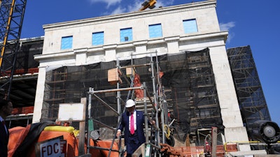 President Trump walks down stairs as he visits the Federal Reserve during renovations, July 24, 2025, Washington.