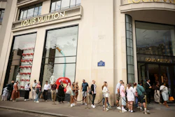 People queue outside the Louis Vuitton store, Paris, July 28, 2025.