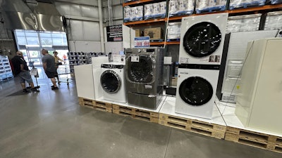 Washers stand on display near the entrance to a Costco warehouse Tuesday, July 8, 2025, in Sheridan, Colo.