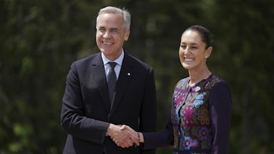 Canada's Prime Minister Mark Carney welcomes Mexican President Claudia Sheinbaum to the G7 Summit in Kananaskis, Alberta, June 17, 2025.