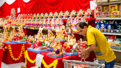 A worker stocks products at New India Bazar, Fremont, Calif., Aug. 6, 2025.
