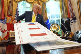 President Trump holds charts as he speaks about the economy in the Oval Office of the White House, Aug. 7, 2025.