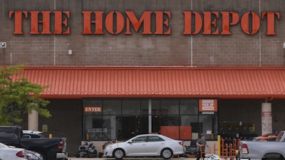 A shopper leaves a Home Depot store, Aug. 14, 2025, Manchester, N.H.