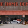 A shopper leaves a Home Depot store, Aug. 14, 2025, Manchester, N.H.