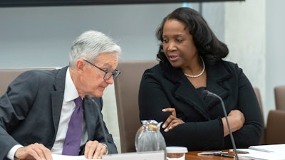 Federal Reserve Board of Governors member Lisa Cook, right, talks with Federal Reserve Chairman Jerome Powell, June 25, 2025, in Washington.