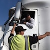 Senior instructor Markus Juarez, bottom, talks to student driver Jaime Rojas at California Truck Driving Academy, Inglewood, Calif., Nov. 17, 2021.