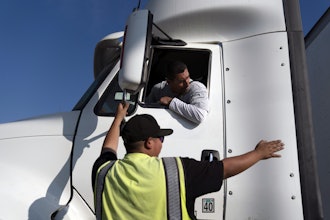 Senior instructor Markus Juarez, bottom, talks to student driver Jaime Rojas at California Truck Driving Academy, Inglewood, Calif., Nov. 17, 2021.