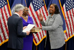 Lisa Cook, right, takes the oath of office to become a member of the Federal Reserve Board, May 23, 2022, Washington.