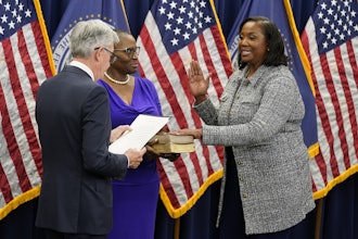 Lisa Cook, right, takes the oath of office to become a member of the Federal Reserve Board, May 23, 2022, Washington.