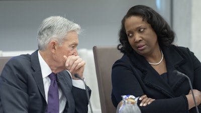 Federal Reserve Chairman Jerome Powell, left, talks with Board of Governors member Lisa Cook, June 25, 2025.