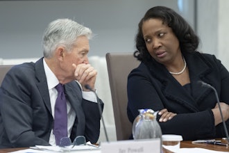 Federal Reserve Chairman Jerome Powell, left, talks with Board of Governors member Lisa Cook, June 25, 2025.
