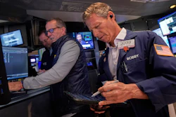 Trader Robert Charmak, right, and specialist Glenn Carell, center, work on the floor of the New York Stock Exchange, Sept. 10, 2025.