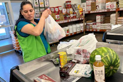 An employee works at a cash register in a grocery store in Schaumburg, Ill., Sept. 18, 2025.