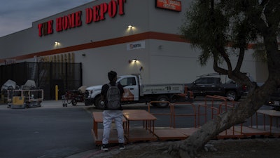 A day laborer waits for work in the parking lot of a Home Depot in the Van Nuys section of Los Angeles, Aug. 28, 2025.