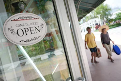 Shoppers walk by a clothing store, Sept. 25, 2025, Miami Beach, Fla.