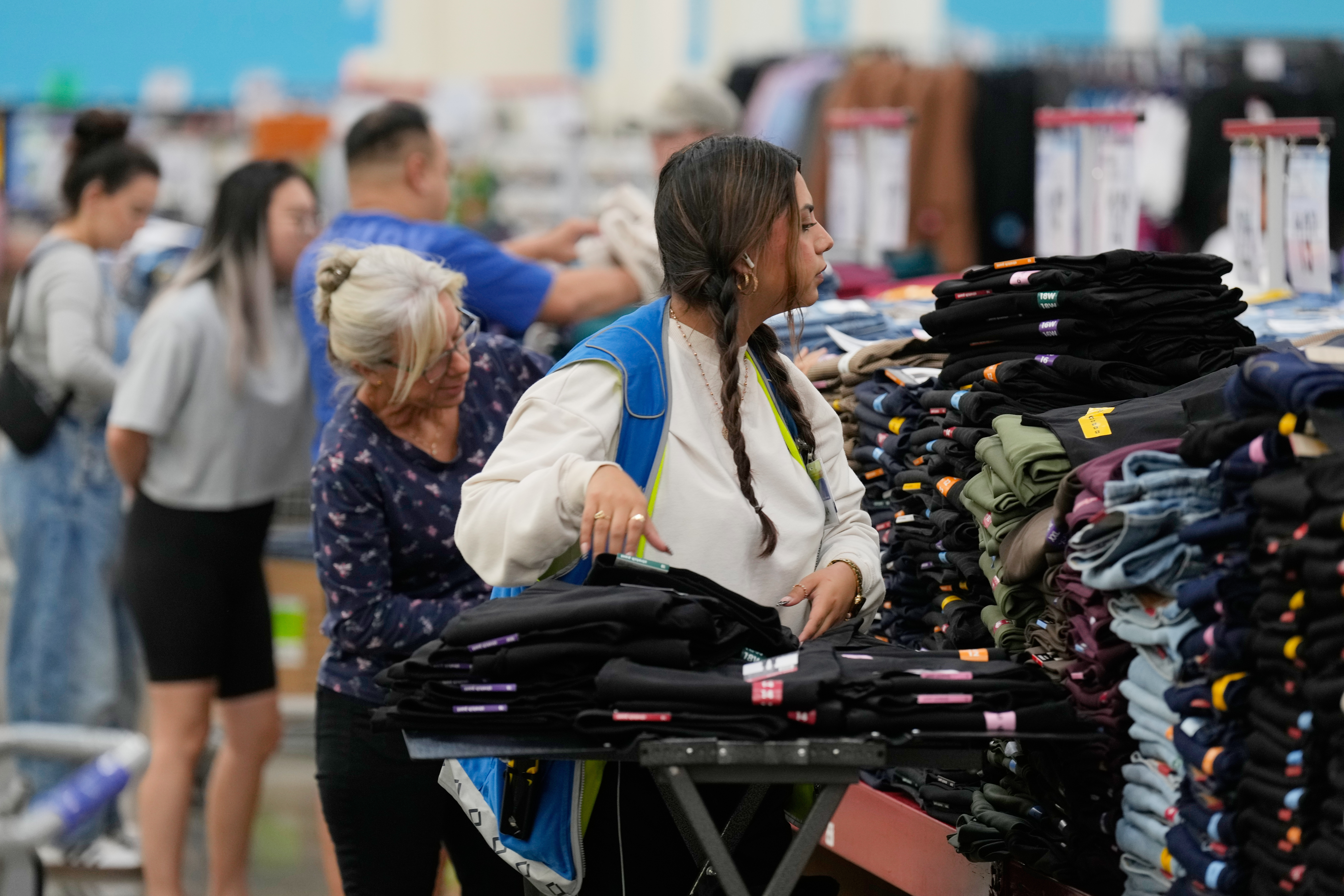 A worker stocks a display of clothing at a Sam's Club, Sept. 24, 2025, in Bentonville, Ark.