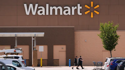Shoppers walk from the Walmart store, Aug. 14, 2025, in Manchester, N.H.