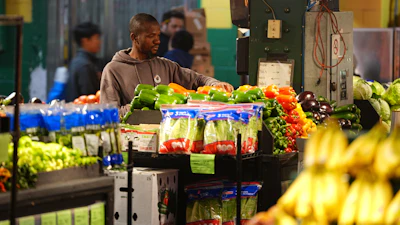 A worker arranges produce at the Reading Terminal Market in Philadelphia, Oct. 29, 2025.