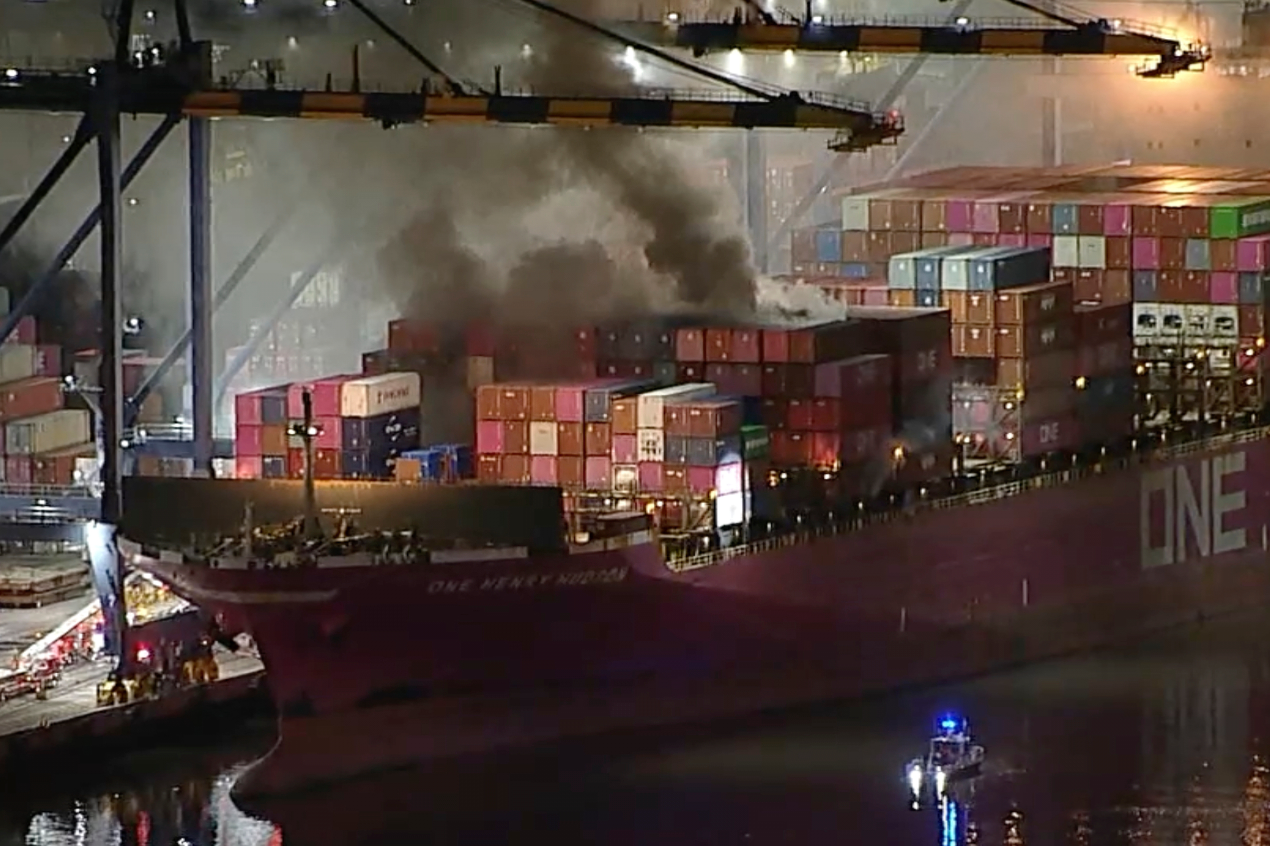 This image taken from video provided by ABC7 shows smoke rising from a blaze on a container ship docked at the Port of Los Angeles, Friday, Nov. 21, 2025, in Los Angeles.