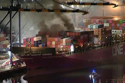 This image taken from video provided by ABC7 shows smoke rising from a blaze on a container ship docked at the Port of Los Angeles, Friday, Nov. 21, 2025, in Los Angeles.