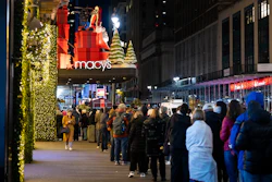 Shoppers wait in line to enter Macy's flagship store on Friday, Nov. 28, 2025.