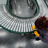 Maintenance technician Liz Cardenas replaces a conveyor belt roller at a training area in a Walmart distribution center Thursday, Sept. 25, 2025, in Bentonville, Ark.