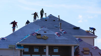 Roofers work atop a house in Anna, Texas, Dec. 18, 2025.