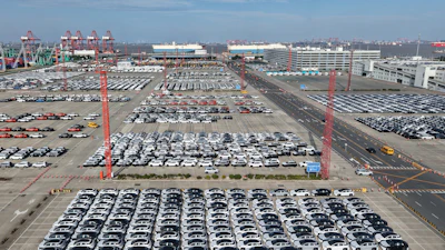 Aerial view of new cars waiting for shipment at a port in Shanghai, Jan. 14, 2026.
