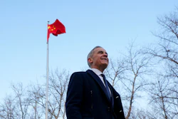 Canadian Prime Minister Mark Carney walks past a Chinese flag after a press conference in Ritan Park, Beijing, Jan. 16, 2026.