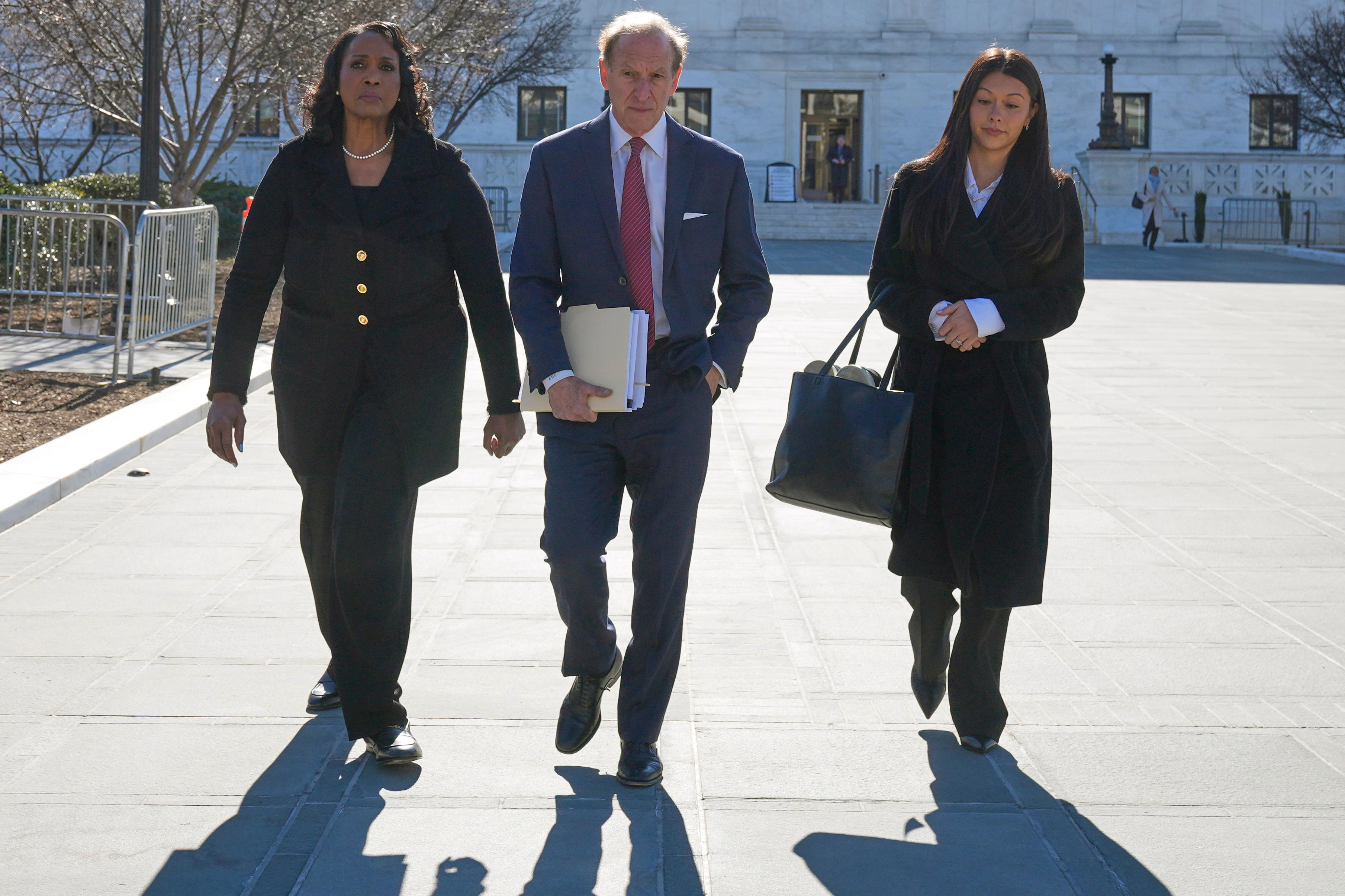 Federal Reserve Governor Lisa Cook, left, and her attorneys leave the Supreme Court in Washington, Jan. 21, 2026.