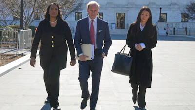 Federal Reserve Governor Lisa Cook, left, and her attorneys leave the Supreme Court in Washington, Jan. 21, 2026.