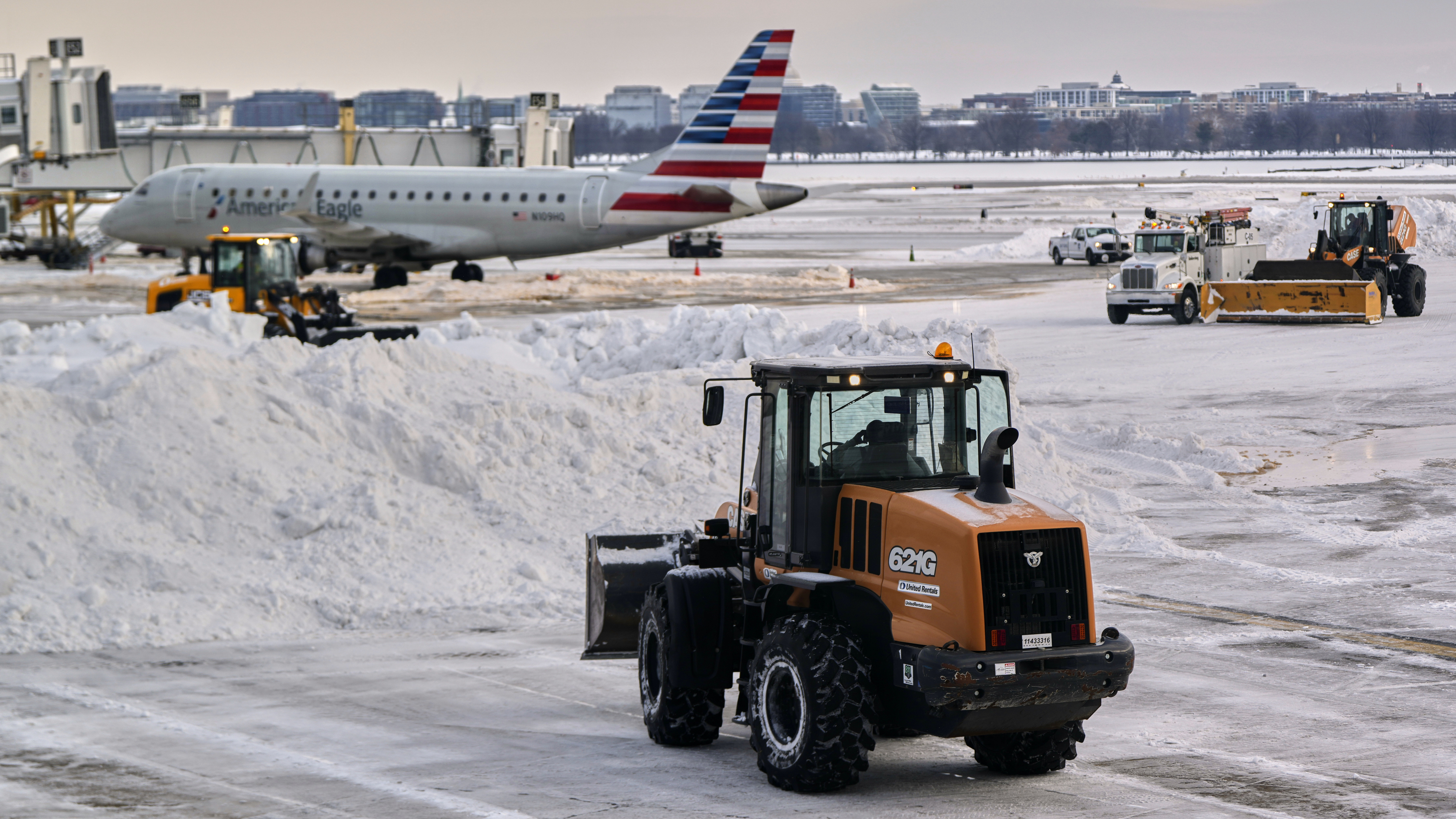 Snow and ice is cleared at Ronald Reagan Washington National Airport, Jan. 26, 2026, Arlington, Va.