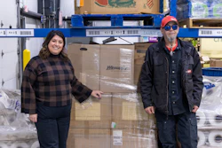 Lee Lauren Truesdale, chief development officer, Dayton Foodbank, with a Dayton Windustrial worker next to donations.