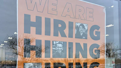 A hiring sign displayed at a grocery store in Arlington Heights, Ill., Dec. 24, 2025.