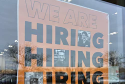 A hiring sign displayed at a grocery store in Arlington Heights, Ill., Dec. 24, 2025.