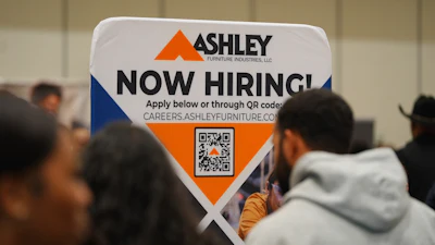 A sign with information about employment is displayed during a job fair in Dallas, Jan. 14, 2026.